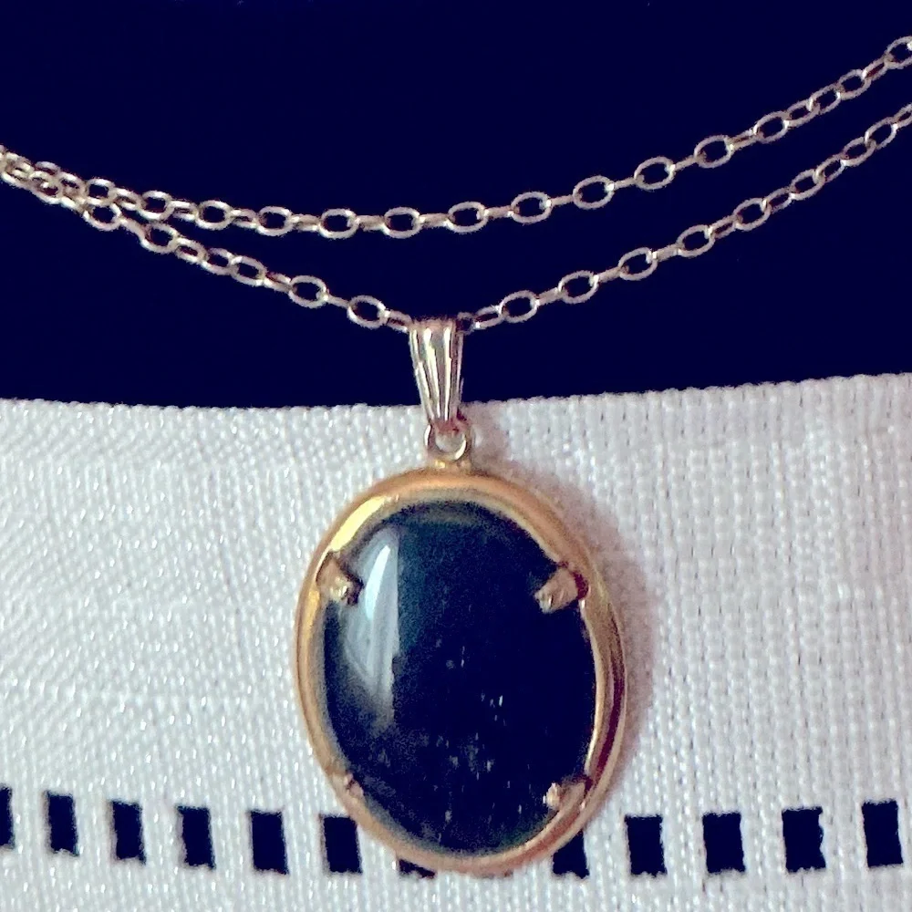 Black Oval Gold Tone Pendant Necklace